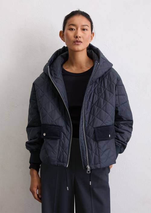 Relaxed hooded quilted jacket made from recycled polyester